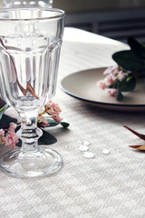  tableware on the festive table, close-up. glass cup and spoon on the table.