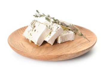 Plate with tasty feta cheese and spices on white background