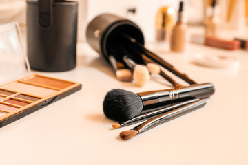 Set of brushes and decorative cosmetics on table of makeup artist