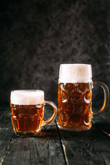 Ginger beer in two mugs, upright, side view