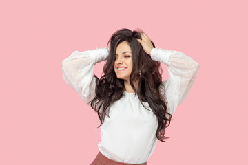Young pretty brunette woman in a white blouse feeling confident