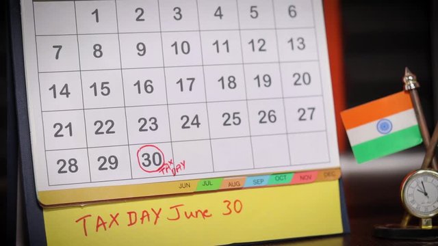 Downward shot of Tax day or deadlines for filing income tax return in india on june 30 marked as reminder in calendar