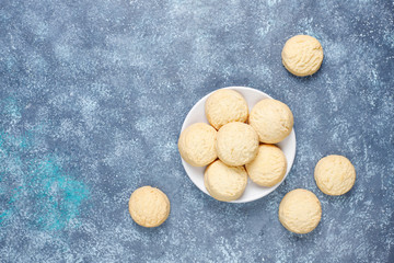 Various cookies in a wooden tray on gray background