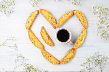 Italian tuscan traditional cookies cantuccini with almonds ,a cup of coffee on light background,top...