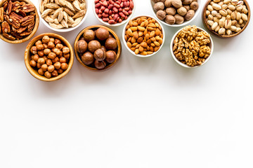 Set of macadamia, hazelnut, walnut, almond, pistachio, pecans nuts on white background top-down...