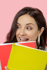 Close up picture of a woman holding notebooks