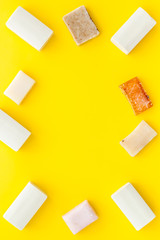 Soap bars flat lay on yellow background top-down copy space frame mockup