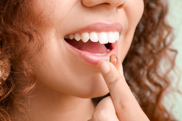 Young woman with fish oil, closeup