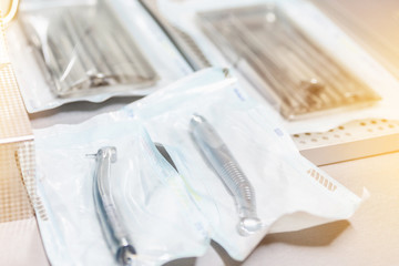 Dental instruments in sterile sealed packaging with blurry background