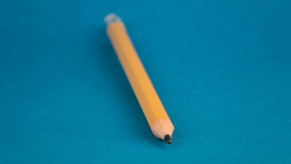 yellow pencil on a blue background