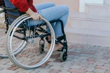 Close up of a young woman in a wheelchair while walking in a park on a sunny day. Recovery and...