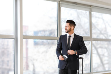 Young businessman with documents at the airport