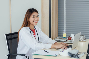 Young Asian doctor working on her desk.