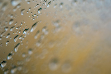water droplets on a golden window 