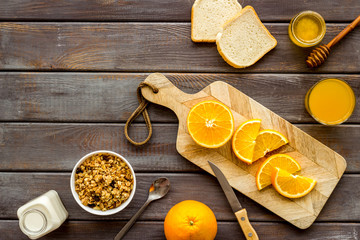 Vegetarian breakfast with granola and fruits on wooden background top-down frame copy space