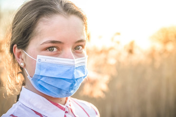 Woman wearing protective mask against coronavirus. Put mask to fight against Corona virus. COVID-19...