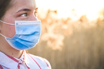 Woman wearing protective mask against coronavirus. Put mask to fight against Corona virus. COVID-19...