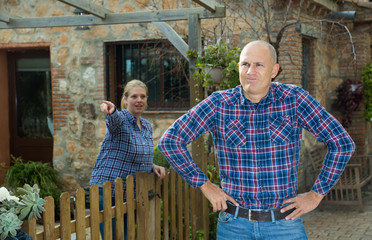 Annoyed man with scolding female neighbor