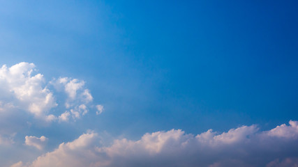 Fototapeta na wymiar A blue sky with beautiful wisp of cloud for use as a backing or backdrop..