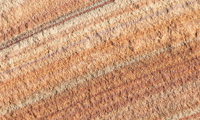 Orange sandstone texture with light and dark veins.
