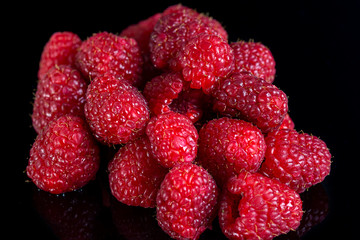 Fresh raspberries close up on a black background
