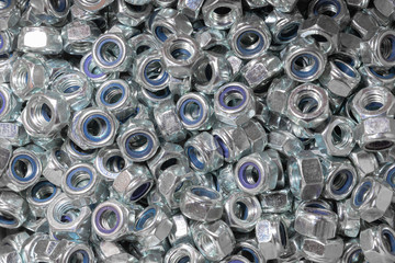Nuts. Texture. A lot of rubberized nuts for bolts and screws. Background for wallpaper. Female screw. Screw-nut. Internal screw.