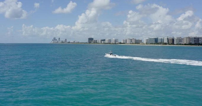 Center Console boat riding along Miami Beach