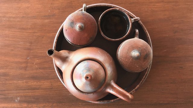 Set of Teh Poci/Poci Tea serving equipments. Consist of tray, pot and cups with lids, handmade of clay/pottery.
