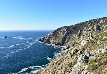 Famous Cape Finisterre or Fisterra known as The End of the World and final stage of Camino de Santiago european religious pilgrimage. Coruña, Galicia, Spain.