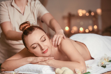 Obraz na płótnie Canvas Beautiful woman receiving massage in spa salon