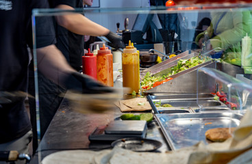Man making lavash kebab in cafe.
