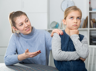 Mother comforts offended little daughter at home