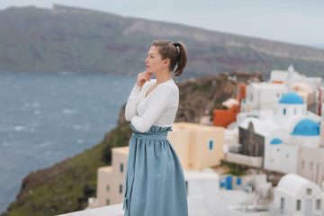 Fototapeta na wymiar young woman looking at santorini island greece