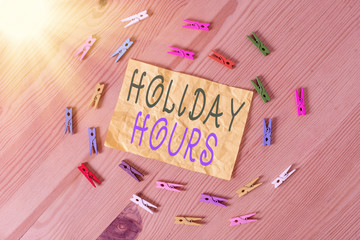 Writing note showing Holiday Hours. Business concept for employee receives twice their normal pay...