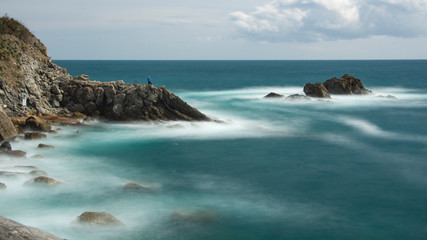 Fototapeta na wymiar Ligurian coast long exposure with rocks and waves