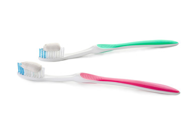 Tooth brushes with paste on white background