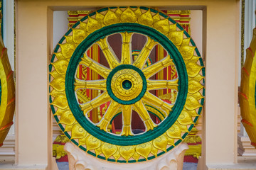 Colorful wheel sculpture in a Buddhist temple in Thailand