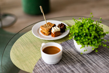 dessert and coffee on table in cafe