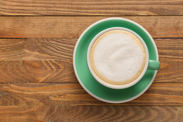 Cup of hot coffee on wooden table