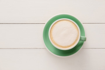 Cup of hot coffee on wooden table