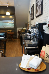 Interior design and decoration of local coffee bar and bakery pastry shop decorated with wooden antique furniture and white brickwall