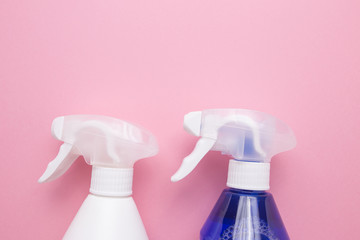Sprays for cleaning on a pink background close-up.