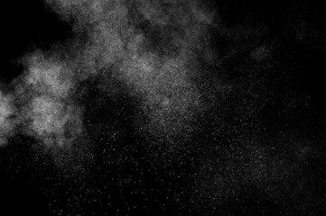 White powder explosion on black background. Abstract white dust texture.