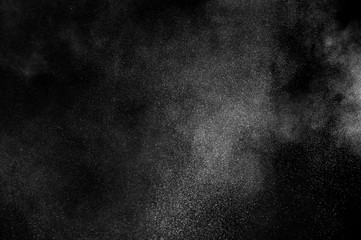 White powder explosion on black background. Abstract white dust texture.