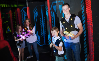 Fototapeta na wymiar Father and son playing laser tag