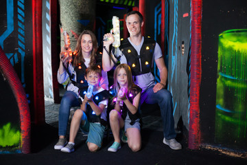 Family posing with laser pistols