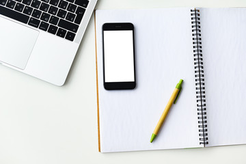 notebook, laptop and phone on the desk