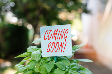 Writing note showing Coming Soon. Business concept for event or action that will happen after...