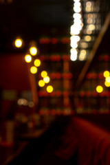 Minimalistic lamps decorated cafe in a modern loft style. Yellow color light. Blurred background as hallway.