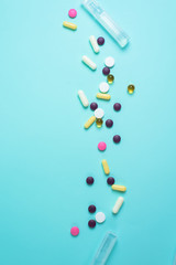 pills coronavirus from the top view. background image. capsules and tablets on a blue background. treatment of infection during a pandemic. The concept, pandemics, coronaviruses, layout.